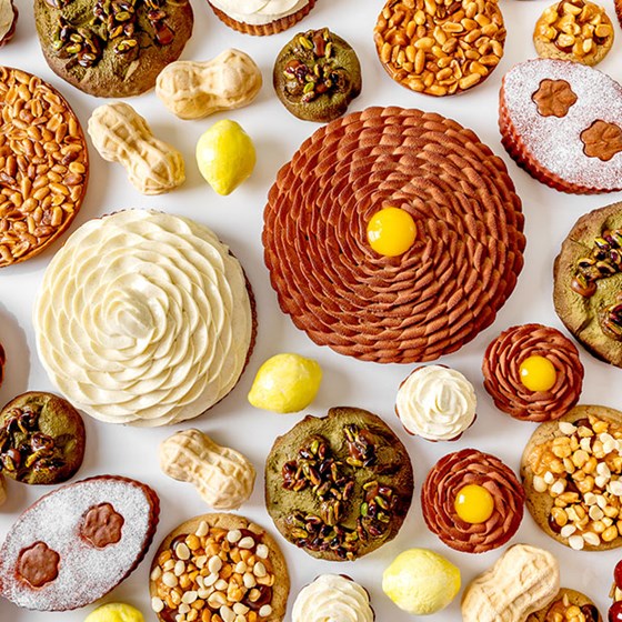Brown, green, yellow and beige cakes by Cedric Grolet
