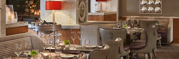 A view of tables at the Collins Room at The Berkeley with tableware and cutlery on them.