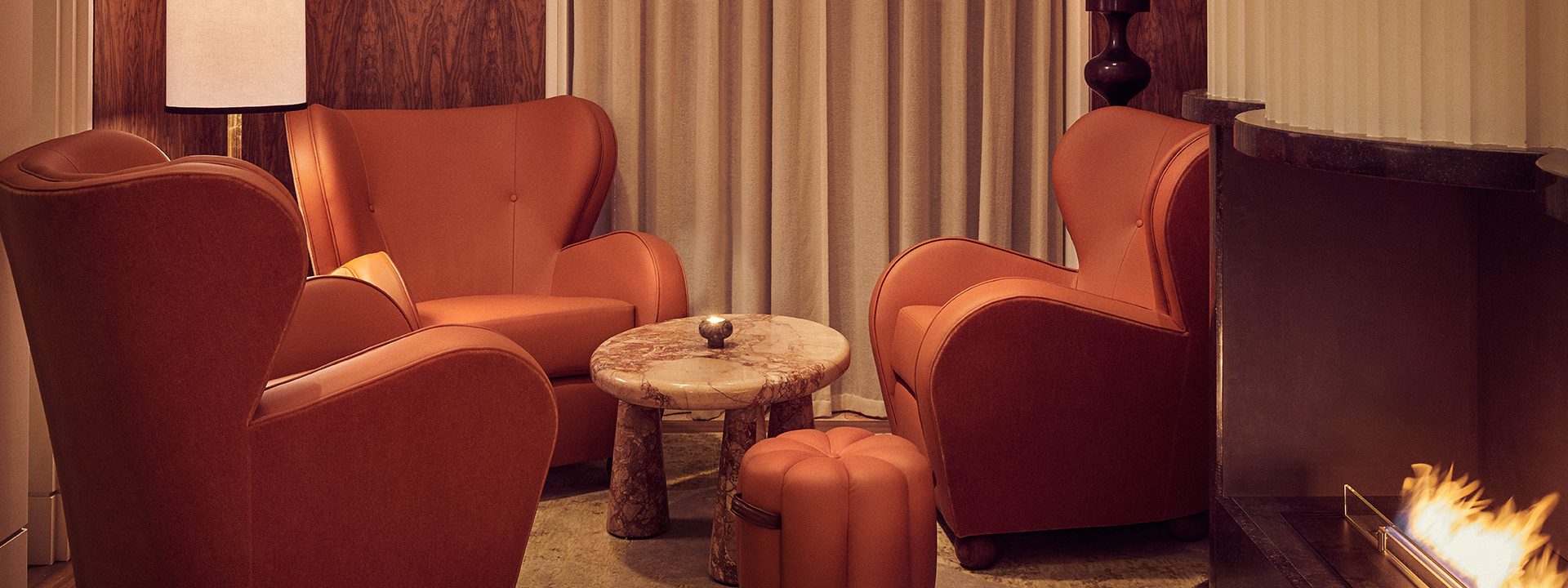 The Berkely Bar & Terrace interior with cognac leather chairs, a marble table next to the fireplace at The Berkeley