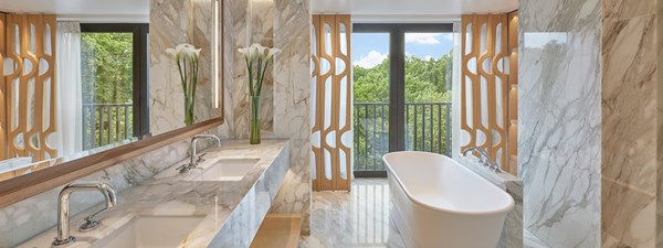 Knightsbridge Pavilion Penthouse at The Berkeley - bathroom view with marble from floor to ceiling and view on the park from the window in the background.